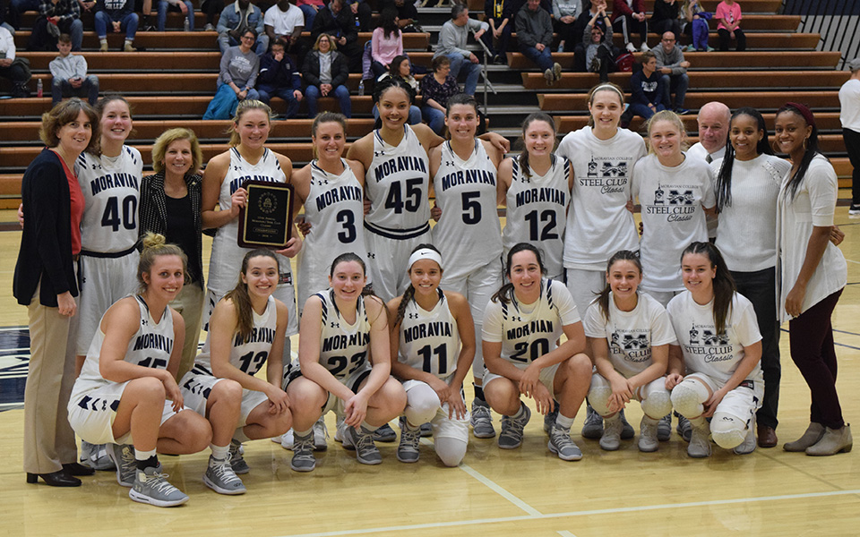 The Greyhounds pose with the 16th Steel Club Classic Championship plaque after winning the tournament for the 11th time in Johnston Hall.