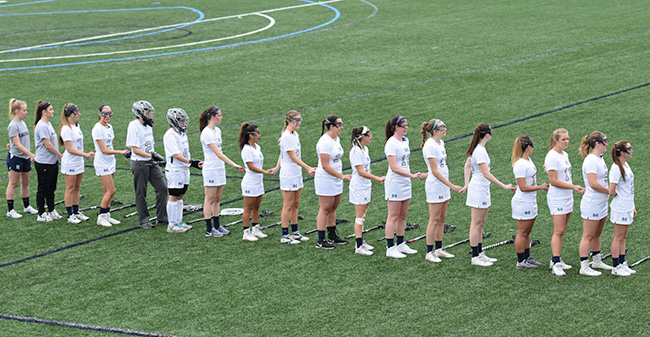 The Greyhounds await the national anthem before a match during the 2017 season.