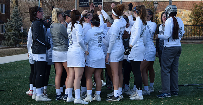 The Greyhounds huddle before the 2018 home opener versus Southern Vermont College.