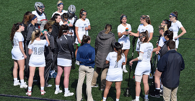 The Greyhounds huddle during a timeout in a match versus Elizabethtown College on John Makuvek Field.