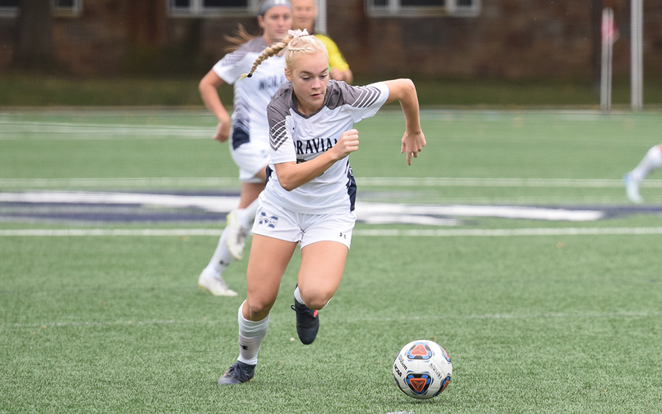 Freshman Megan Chesney moves down the field with the ball versus Alvernia University.