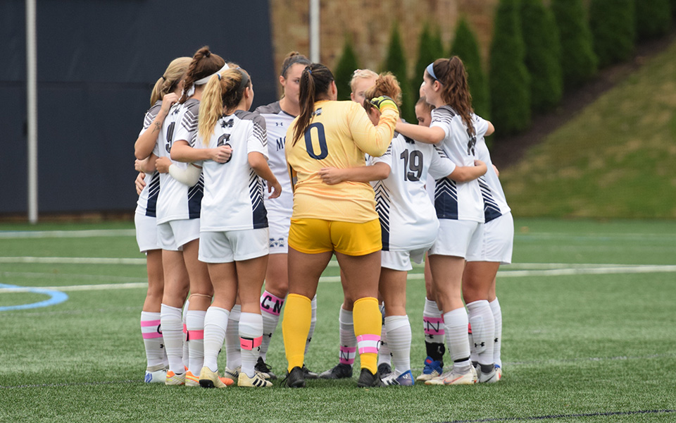 The Greyhounds huddle before the start of the first half versus The University of Scranton on John Makuvek Field.