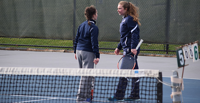 Lauren Steinert '20 and Mary Angle '21 talk during doubles action versus Ursinus College at Hoffman Courts.
