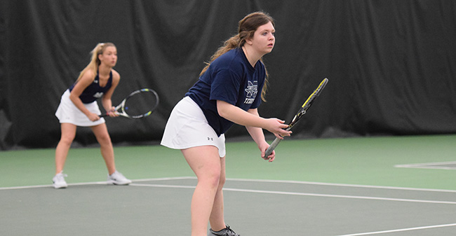 Kristen Cassidy '21 and Brooke Adams '21 await a serve in doubles action versus Bryn Mawr College in March 2018.