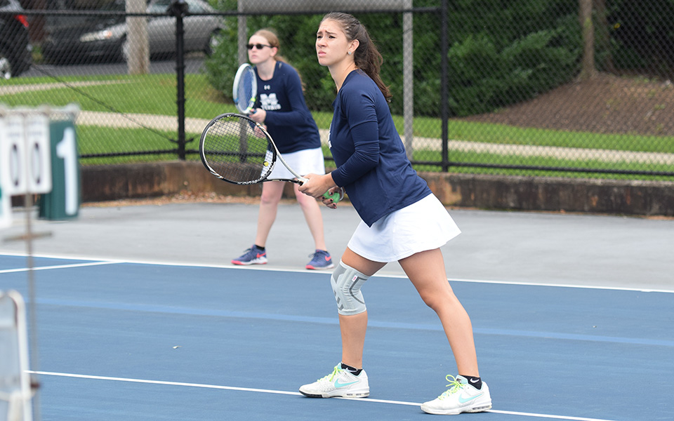 Sophomores Nicole Peluso and Destiny George await a serve in doubles action versus Cedar Crest College at Hoffman Courts.