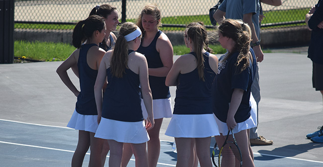 The Greyhounds huddle before a 2018 Landmark Conference Semifinal match at Hoffman Courts versus The Catholic University of America.