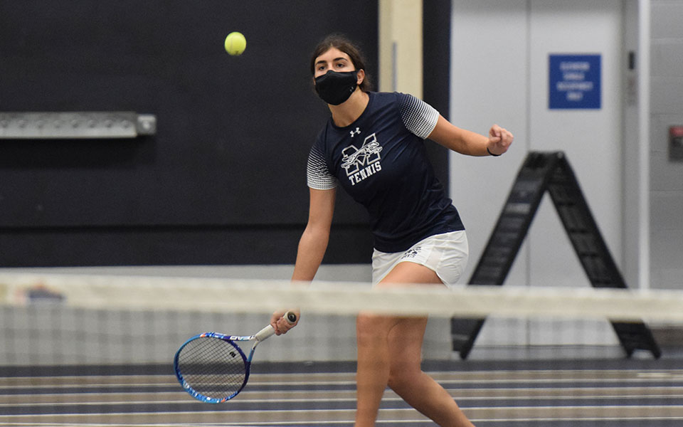 Cristina Merone '23 returns the final shot to win her third doubles match with Julianne Cassady '23 in the Landmark Conference Semifinals versus Drew University in Timothy Breidegam Fieldhouse on May 5, 2021.
