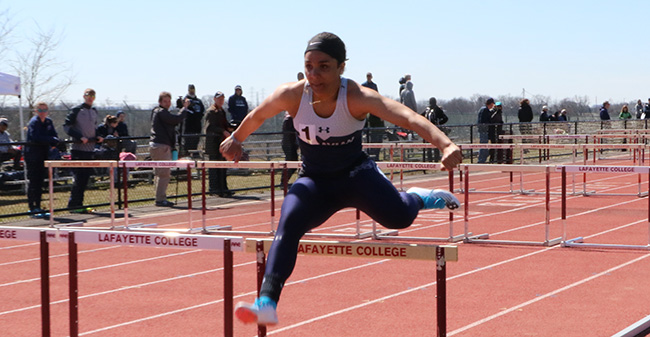 Amari Schooler '19 goes over a hurdle in the 100-meter hurdles at the Lafayette 8-Way Meet.