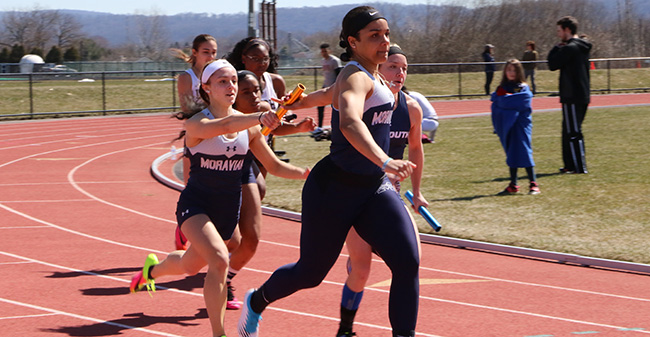 Amari Schooler '19 takes a handoff from Camaryn Wheeler '21 in the 4x100-meter relay at the Lafayette College 8-Way Meet in March 2018.