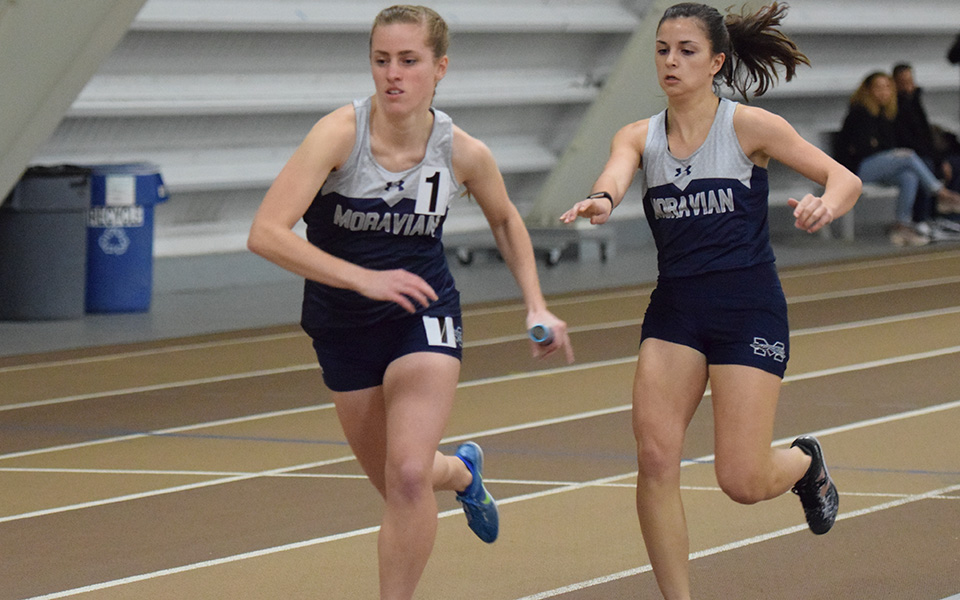Senior Carly Danoski takes the baton from freshman Natalie Stabilito in the 4x400-meter relay at the Lehigh University Fast Times Before Finals.