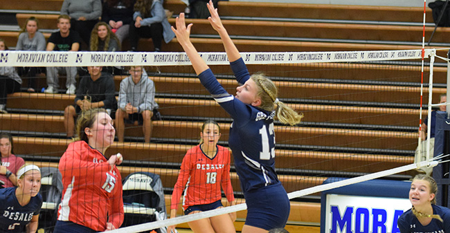 Madi Anslow '21 goes up for a block in a match against DeSales University.
