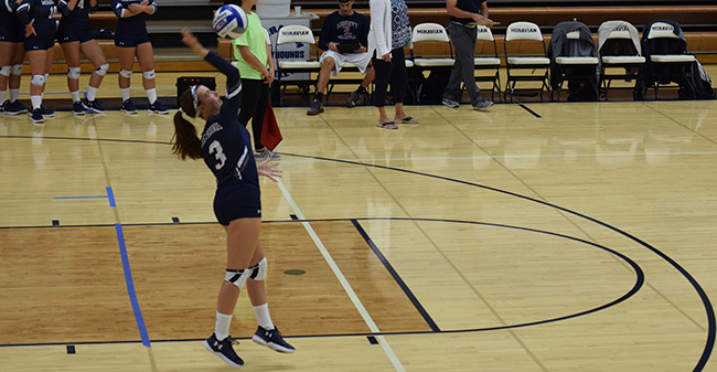 Alexis Szaro '20 serves up the ball in a match versus DeSales University.
