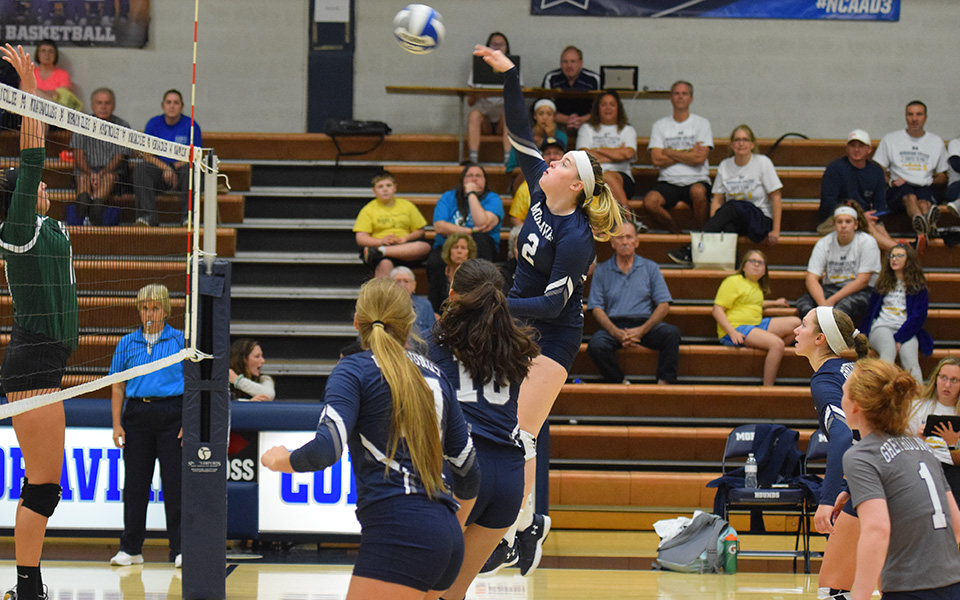 Freshman Jess Appleton attacks a ball over the net versus Farmingdale State College in Johnston Hall.
