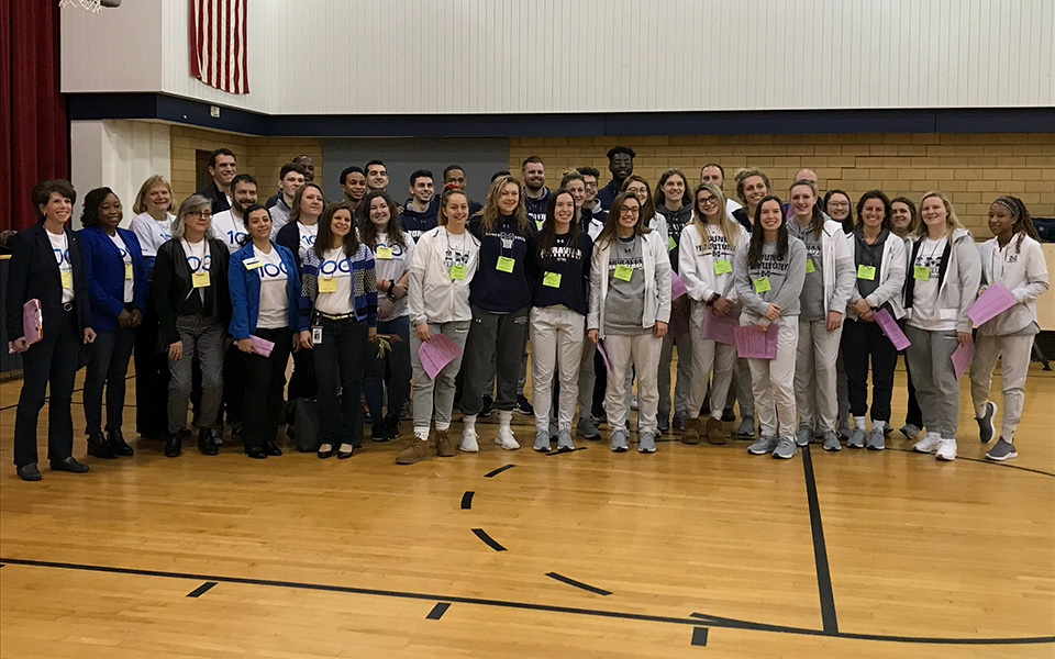 The men's and women's basketball teams at Thomas Jefferson Elementary School on January 17th to participate in a Cops 'n Kids event and the school's Martin Luther King Jr. Day Celebration.