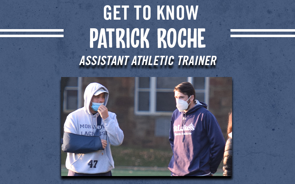 Patrick roche talking with an injured men's lacrosse player.