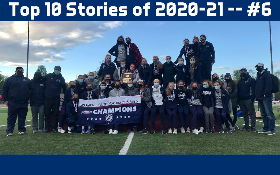 2021 women's track & field team on the podium at Susquehanna after winning landmark conference title