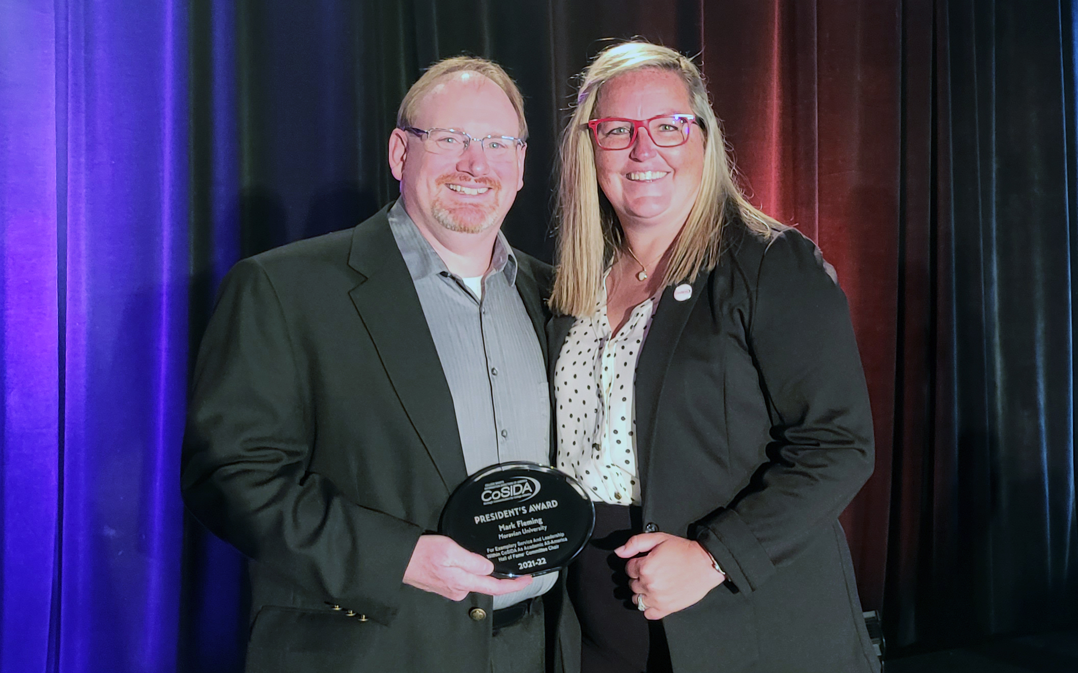 Mark Fleming received CoSIDA's President's Award, presented by 2021-22 CoSISA President Cindy Potter in Las Vegas, Nevada.