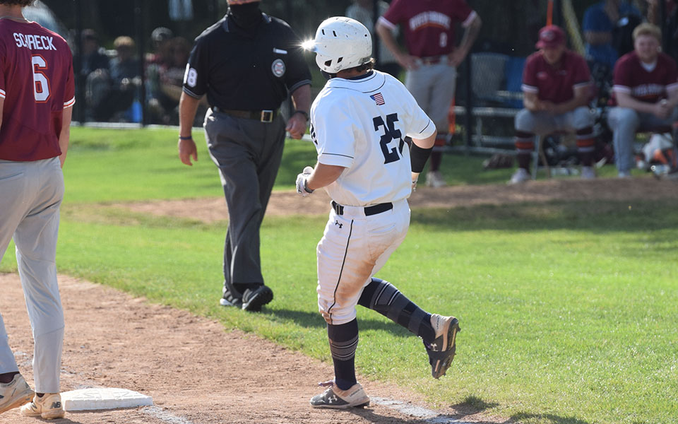 Brett Moyer '21 rounds first base after a hit during a Landmark Conference Tournament game at Gillespie Field on May 13, 2021.