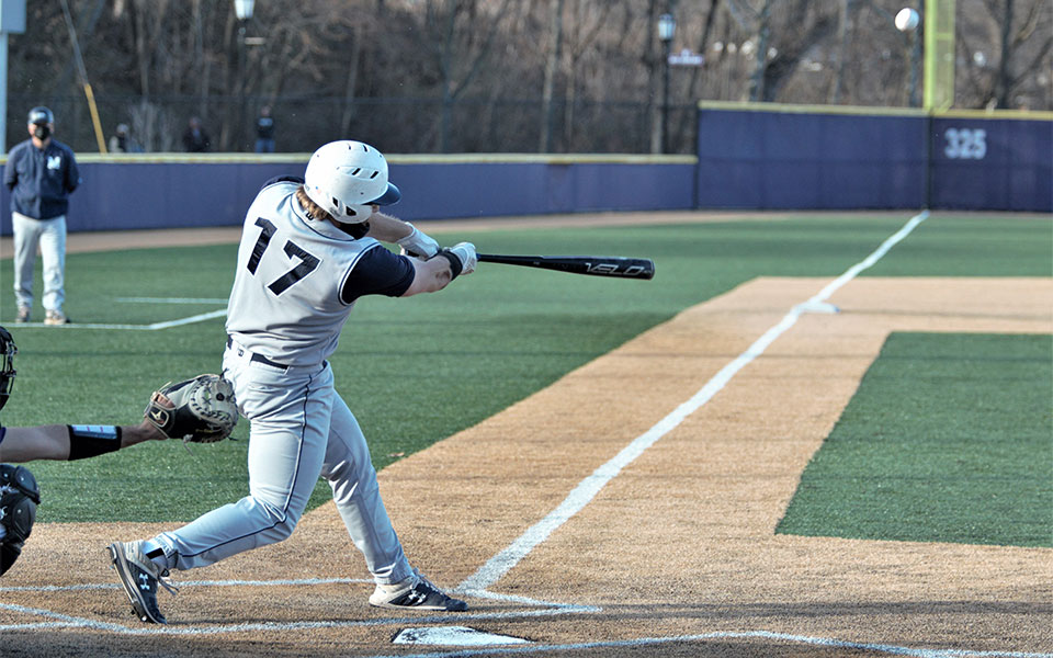 Thomas Philipps '21 connects on a solo home run during the first game of a doubleheader at the University of Scranton. Photon by Timothy R. Dougherty / Double Eagle Photography.