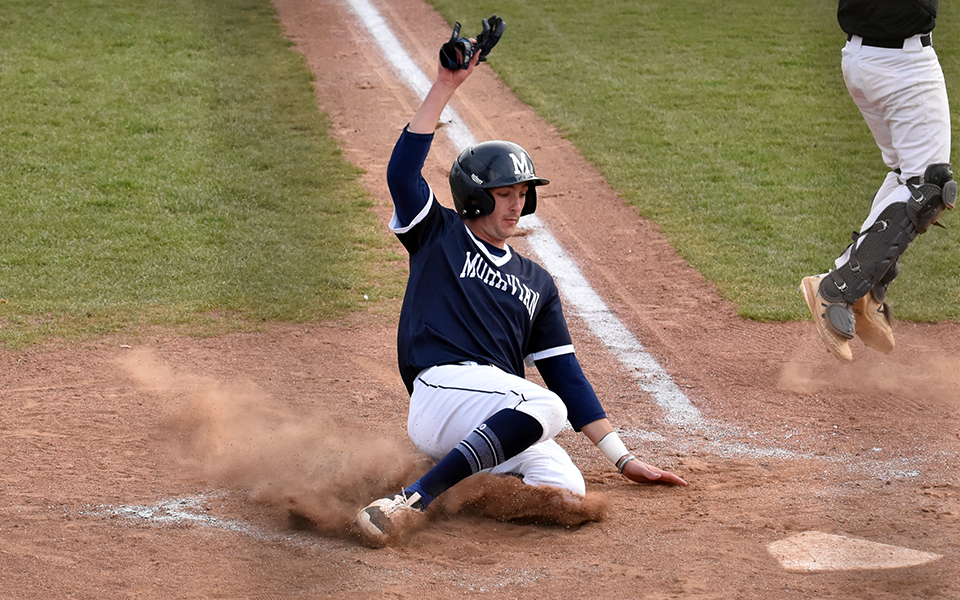 Sophomore third baseman Paul Croyle slides across the plate in the fourth inning of the Greyhounds' win over Rosemont College at Gillespie Field.