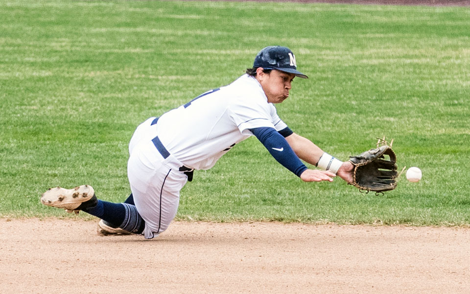 Junior second baseman Chris Pow dives to make a stop in a game versus Juniata College at Gillespie Field in March 2022. Photo by Cosmic Fox Media / Matthew Levine '11