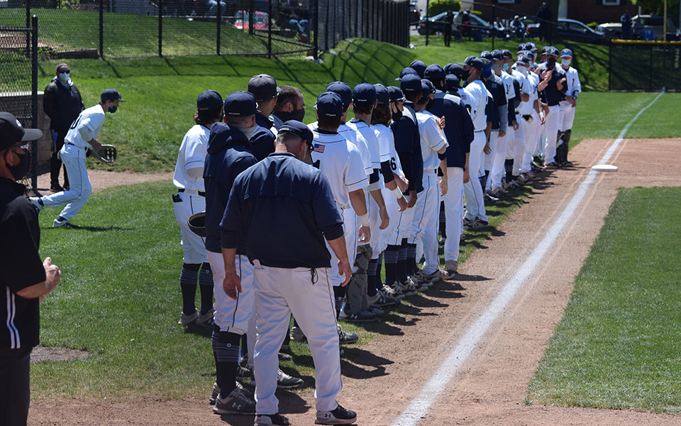 The Greyhounds line up down the third base line for the starting lineup introductions versus Elizabethtown College in a Landmark Conference doubleheader at Gillespie Field on May 1, 2021. Photo by Mairi West '23