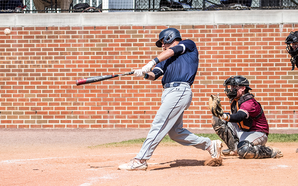 Senior designated hitter Derek Holmes connects on a home run in the first game of a Landmark Conference doubleheader versus Susquehanna University at Gillespie Field. Photo by Cosmic Fox Media / Matthew Levine '11