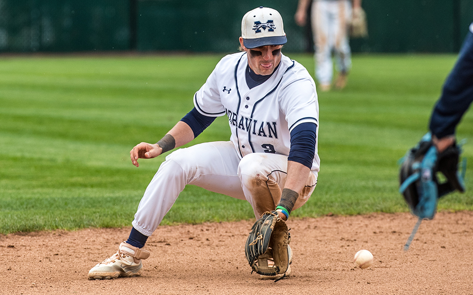 Senior shortstop Paul Croyle backhands a ball in the hole versus Juniata College at Gillespie Field. Photo by Cosmic Fox Media / Matthew Levine '11