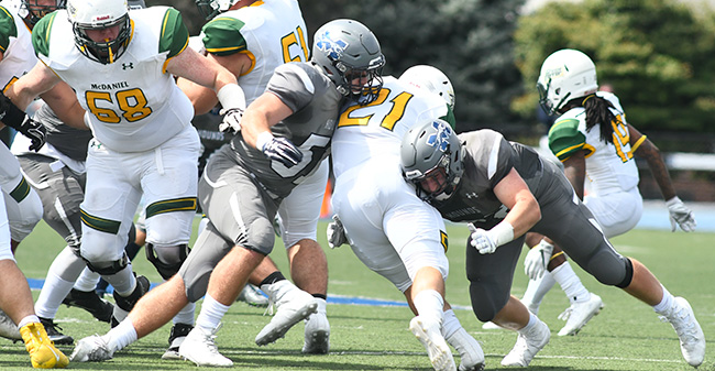 Nick Tone '19 and Shane Mastro '21 combine on a tackle against McDaniel College on Rocco Calvo Field.