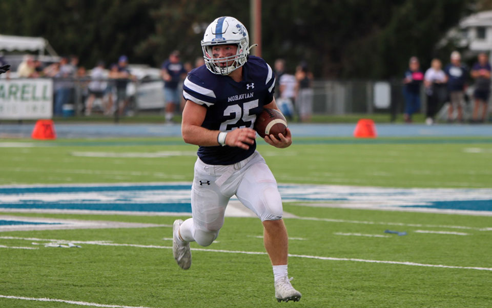 Nate Boyle carries the ball versus Dickinson College at Rocco Calvo Field on Homecoming. Photo by Ashley Hacker '25.