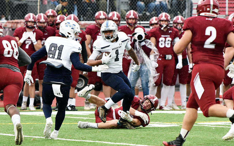 Senior running back Carrington Smith breaks a tackle on a rushing attempt at Muhlenberg College.