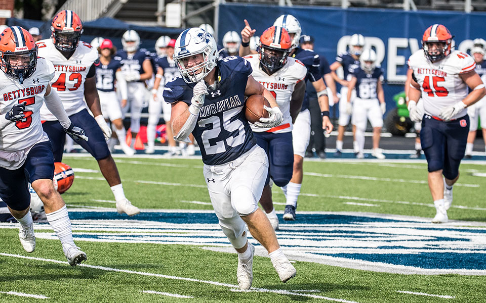 Sophomore running back Nate Boyle makes a cut around the end of the line during the Greyhounds' win over Gettysburg College at Rocco Calvo Field. Photo by Cosmic Fox Media / Matthew Levine '11