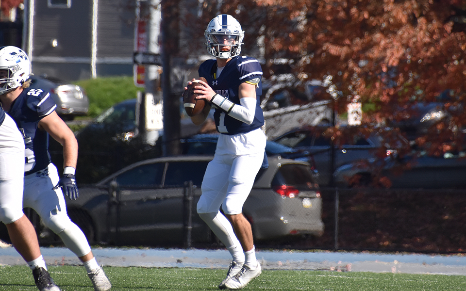Junior quarterback Brad Bryan looks to throw a pass against McDaniel College at Rocco Calvo Field on Homecoming. Photo by Ava Edwards '22.
