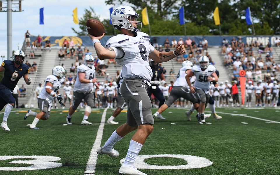 Sophomore Jared Jenkins rolls out to throw a pass at The College of New Jersey. Photo by Jimmy Alagna/TCNJ Athletics