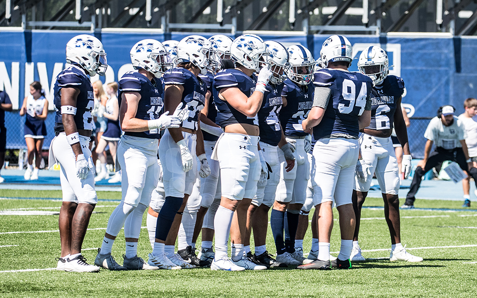 The Greyhounds huddle before a kickoff versus Gettysburg College at Rocco Calvo Field earlier this season. Photo by Cosmic Fox Media / Matthew Levine '11