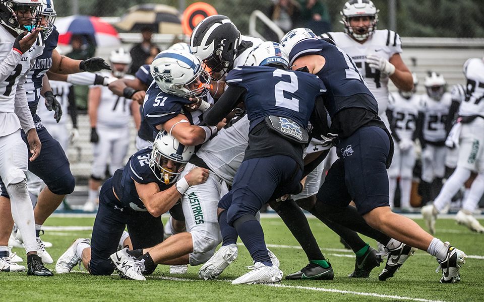 The Greyhounds defense makes a stop at the line of scrimmage versus SUNY Morrisville on Homecoming at Rocco Calvo Field. Photo by Cosmic Fox Media / Matthew Levine '11