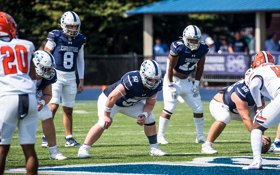 The Greyhounds' offense gets set to snap the ball in the first half versus Utica (N.Y.) University at Rocco Calvo Field earlier in the 2024 season. Photo by Cosmic Fox Media / Matthew Levine '11