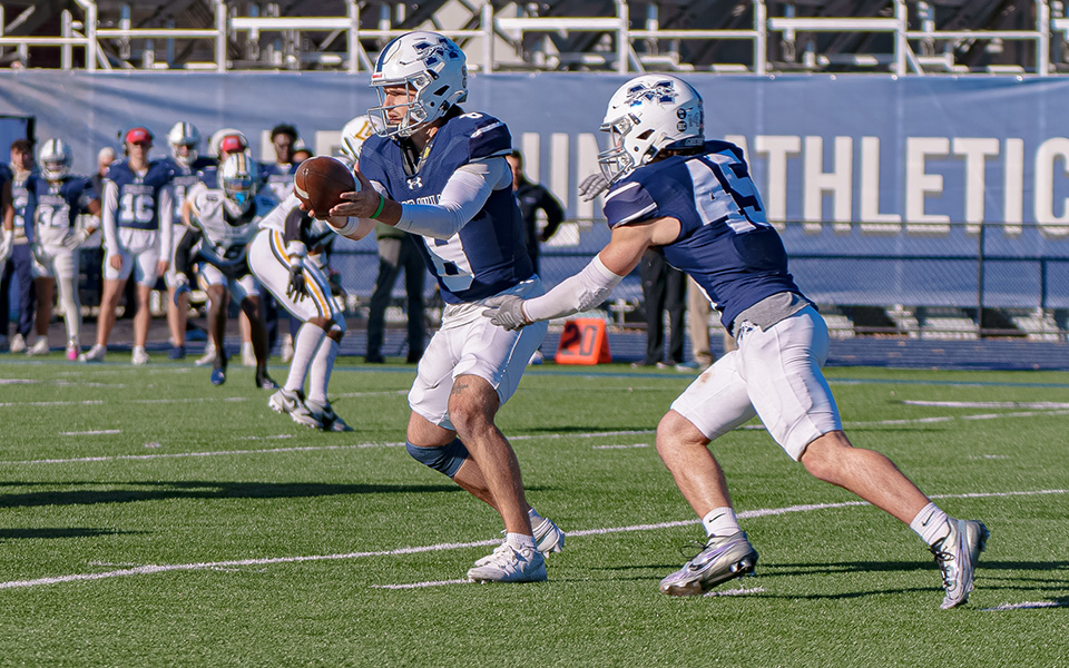 Senior quarterback Jared Jenkins hands off to freshman running back Jed Bendekovits versus Lycoming College at Rocco Calvo Field. Photo by Ralph Lucchese