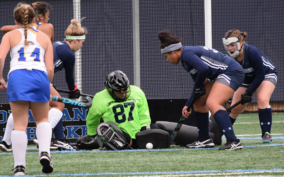 Ashley Kunsman makes a save on a penalty corner versus Goucher College during the 2018 season with Devyn Lapp, Talea Gordon and Emily Duddy ready to clear the ball.