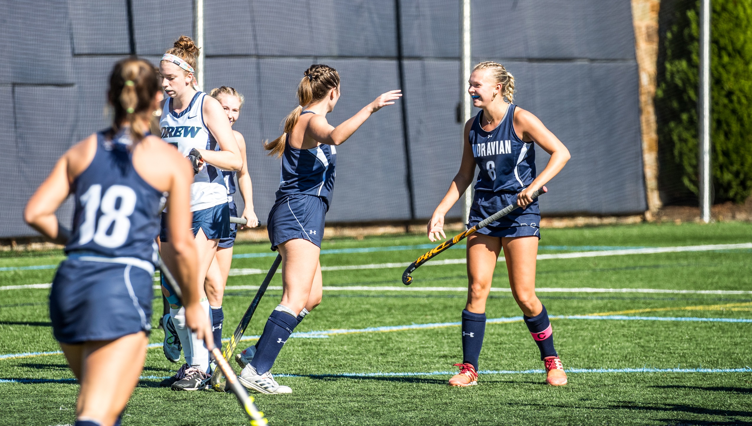 Sophomore Sydney Anderson and senior Maddie Call celebrate a goal in a match versus Drew University earlier this season on John Makuvek Field. Photo by Cosmic Fox Media / Matthew Levine '11