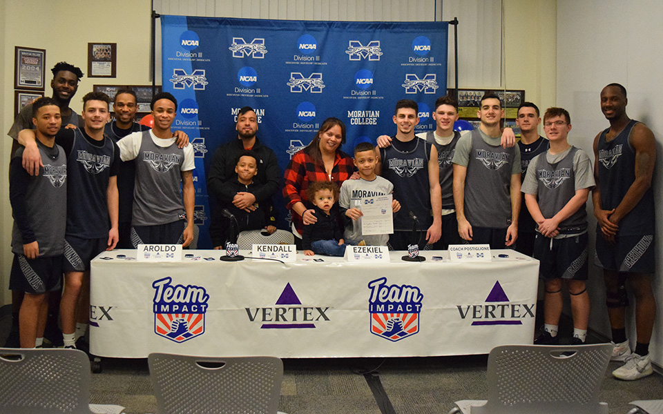 Ezekiel Rodas, his family and the Greyhounds after Ezekiel officially signed his letter to join the men's basketball program at Moravian.