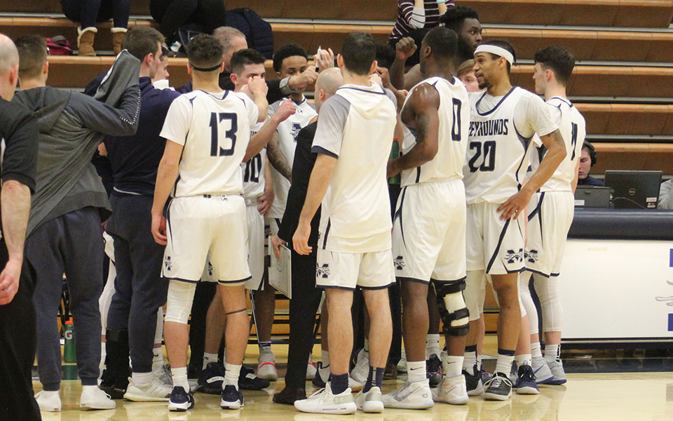 The Greyhounds huddle during a timeout versus Susquehanna University in Johnston Hall.