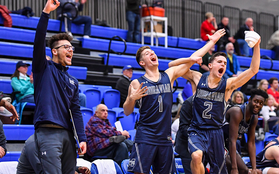The Greyhounds' bench celebrates a basket during the NCAA Division III Tournament versus Keene State (N.H.) in New York during the 2018-19 NCAA First Round.