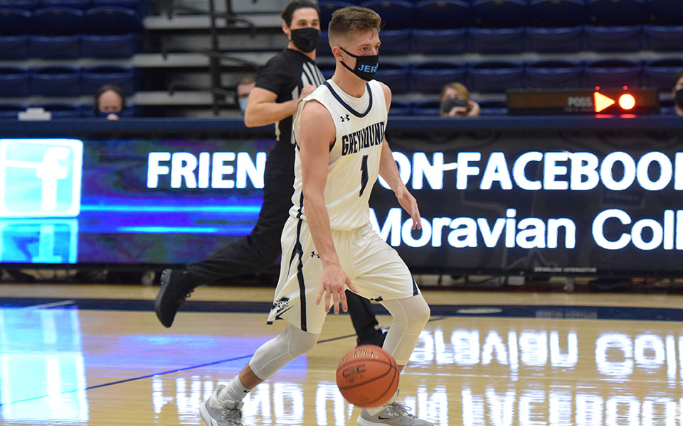 Keith Otto '21 dribbles up the court in the first half versus Juniata College in the 2021 season opener in Johnston Hall.