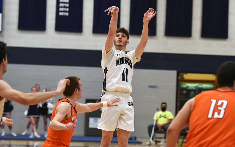 Junior guard Nate Dougherty shoots a three-pointer in the first half of a game versus Susquehanna University in Johnston Hall during the 2021-22 season. Photo by Mairi West '23