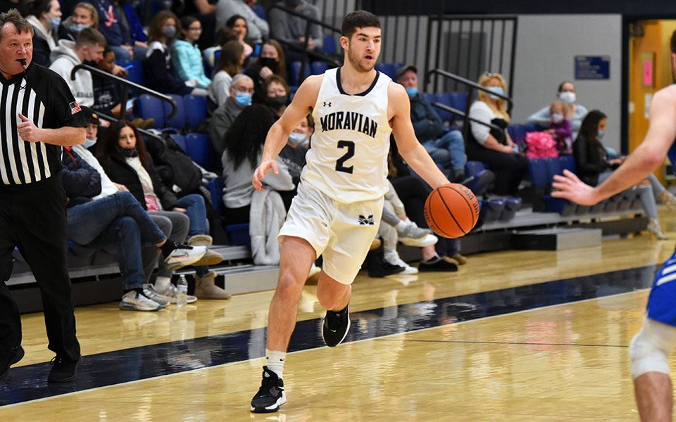 Senior guard Danny Cooper brings the ball up the court during the first half versus Elizabethtown College in Johnston Hall. Photo by Mairi West '23