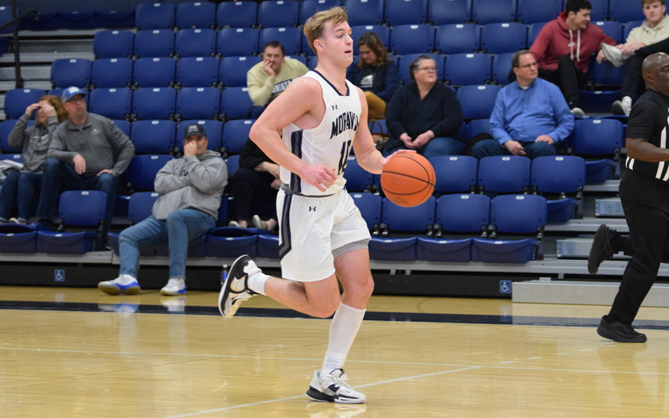 Freshman guard Porter Kelly dribbles the ball up court during the second half versus Juniata College in Johnston Hall.