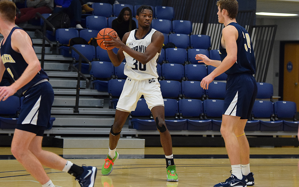 Freshman forward Marquis Ratcliff looks to pass in the second half of a game with Juniata College in Johnston Hall.