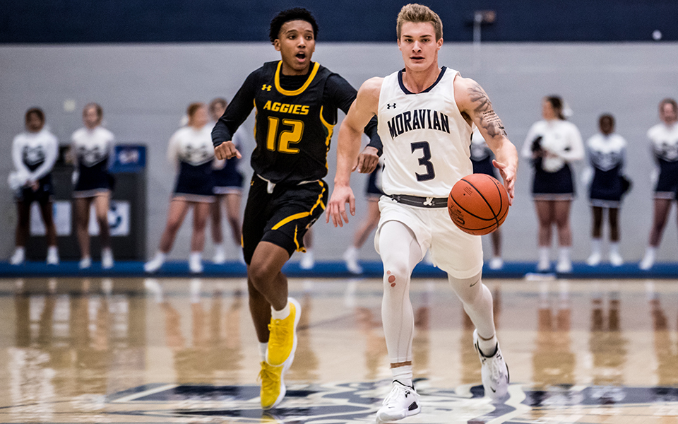 Guard C.J. Weber dribbles up the court in the first half of a game versus Delaware Valley University in Johnston Hall during the 2021-22 season. Photo by Cosmic Fox Media / Matthew Levine '11