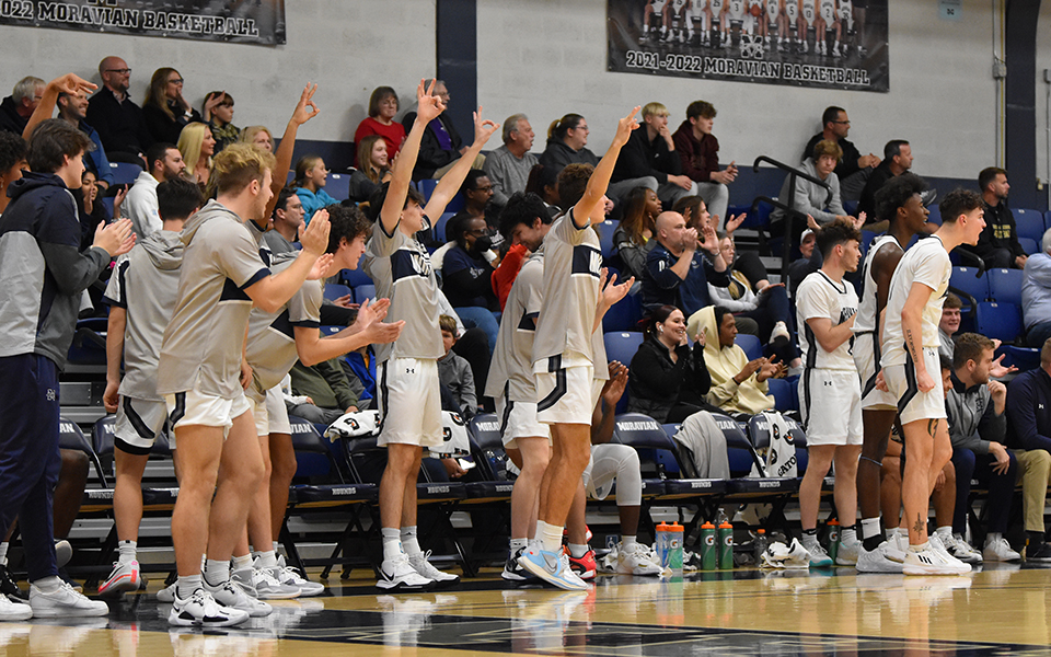 The Greyhounds' bench celebrates a three-pointer versus rival Muhlenberg College in the 2022-23 season opener in Johnston Hall. Photo by Mairi West '23